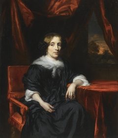 Portrait of a Woman in a Black Dress seated in a Red Velvet chair by Nicolaes Maes