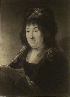 Woman wearing a turban holding a book by Rembrandt