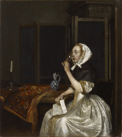 Young woman with a glass of wine, holding a letter in her hand by Gerard ter Borch