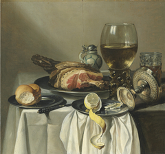 Still life with ham, lemon, a roll, a glass of wine, and others on a table by Pieter Claesz