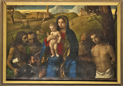 Madonna and Child with Four Saints and Donor by Giovanni Bellini