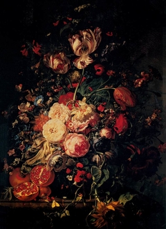 Flowers in a glass vase, with pomegranites, on a marble balustrade by Rachel Ruysch