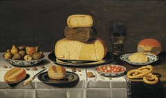 Laid table with cheese, bread, fruit and a roemer by Floris van Schooten