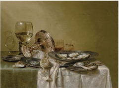 Still life with an overturned tazza and oysters by Willem Claesz Heda