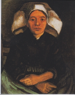 Peasant woman, seated, with a white hood by Vincent van Gogh