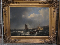 Stormy sea, on the right a beach with a light house by Johannes Christiaan Schotel